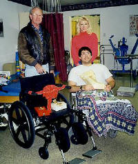 Directors Mary Masters and her father Clarke deliver a new wheelchair!